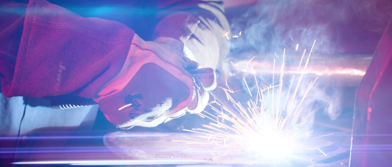 Commercial — sparks flying from a welder for CMU Tech